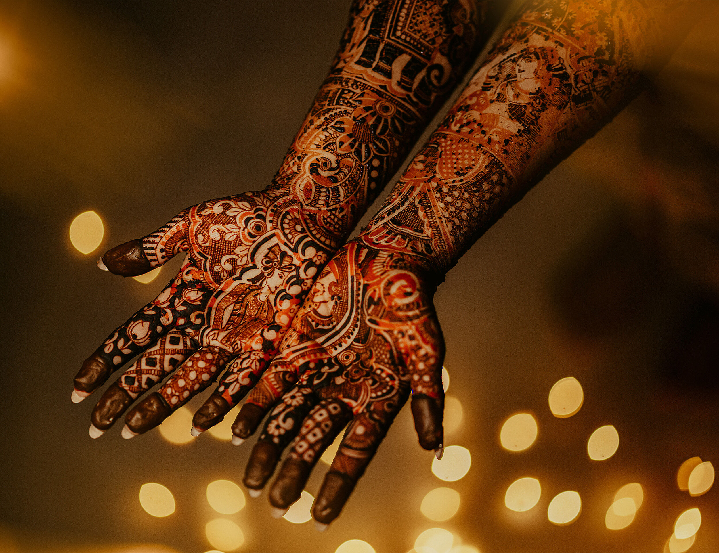 Bride elegantly flaunting her beautifully detailed mehendi, a symbol of wedding traditions